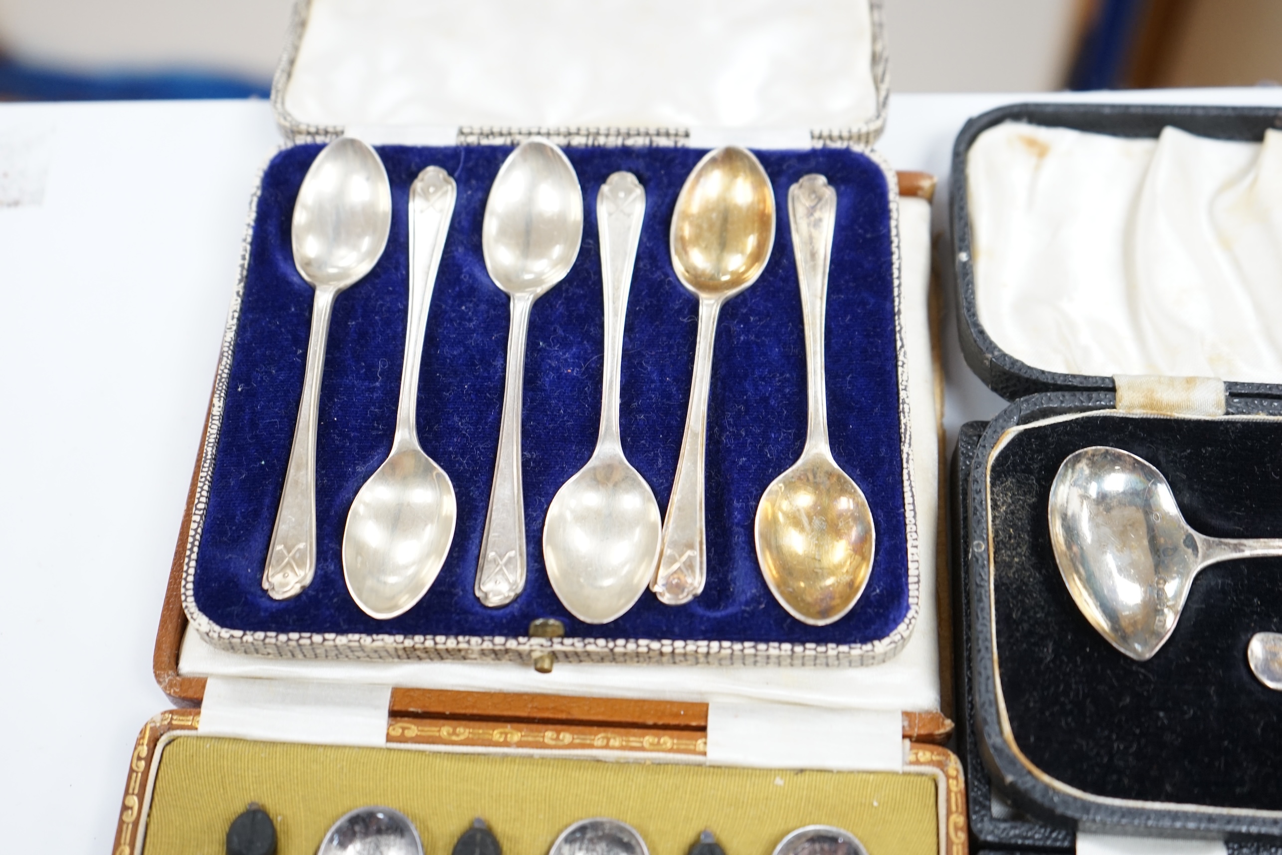 Two cased sets of six silver coffee spoons including bean end and golfing related and two cased silver christening spoons and pushers. Condition - poor to fair